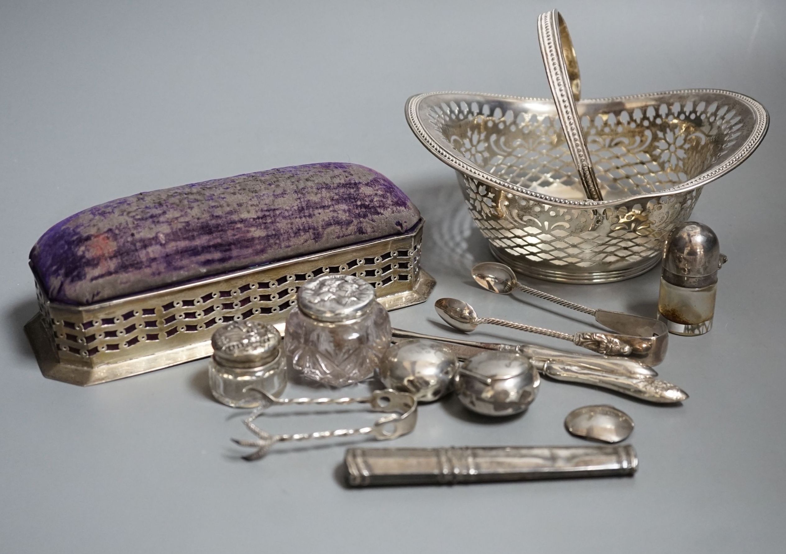 Small silver including two pill boxes, a silver mounted pin cushion, a sterling bonbon basket, etc.